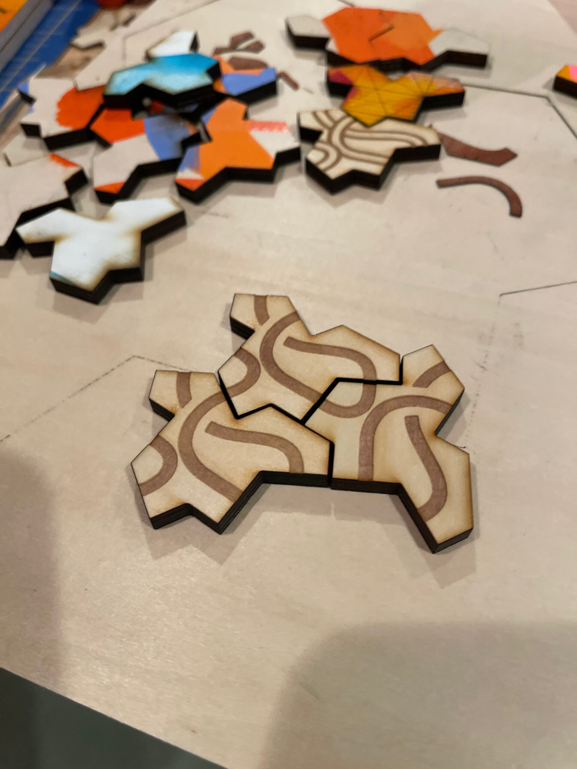 Natural wood Einstein tiles with engraved road network assembled together