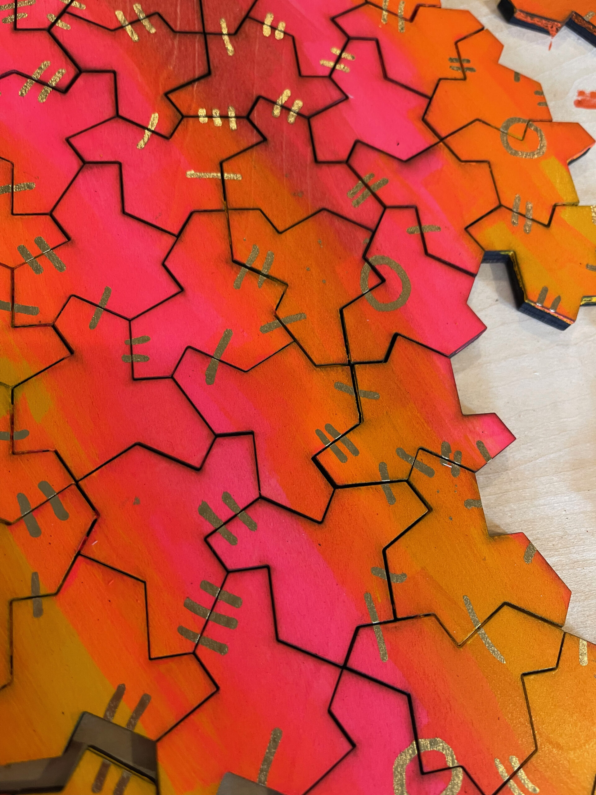 Close-up of final Einstein tiles showing gold shared markings across tile edges