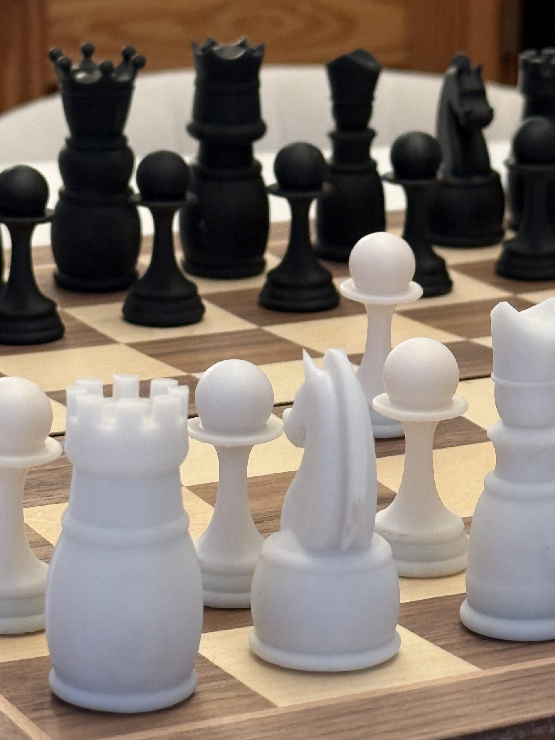 Close-up of black and white chess pieces on the board