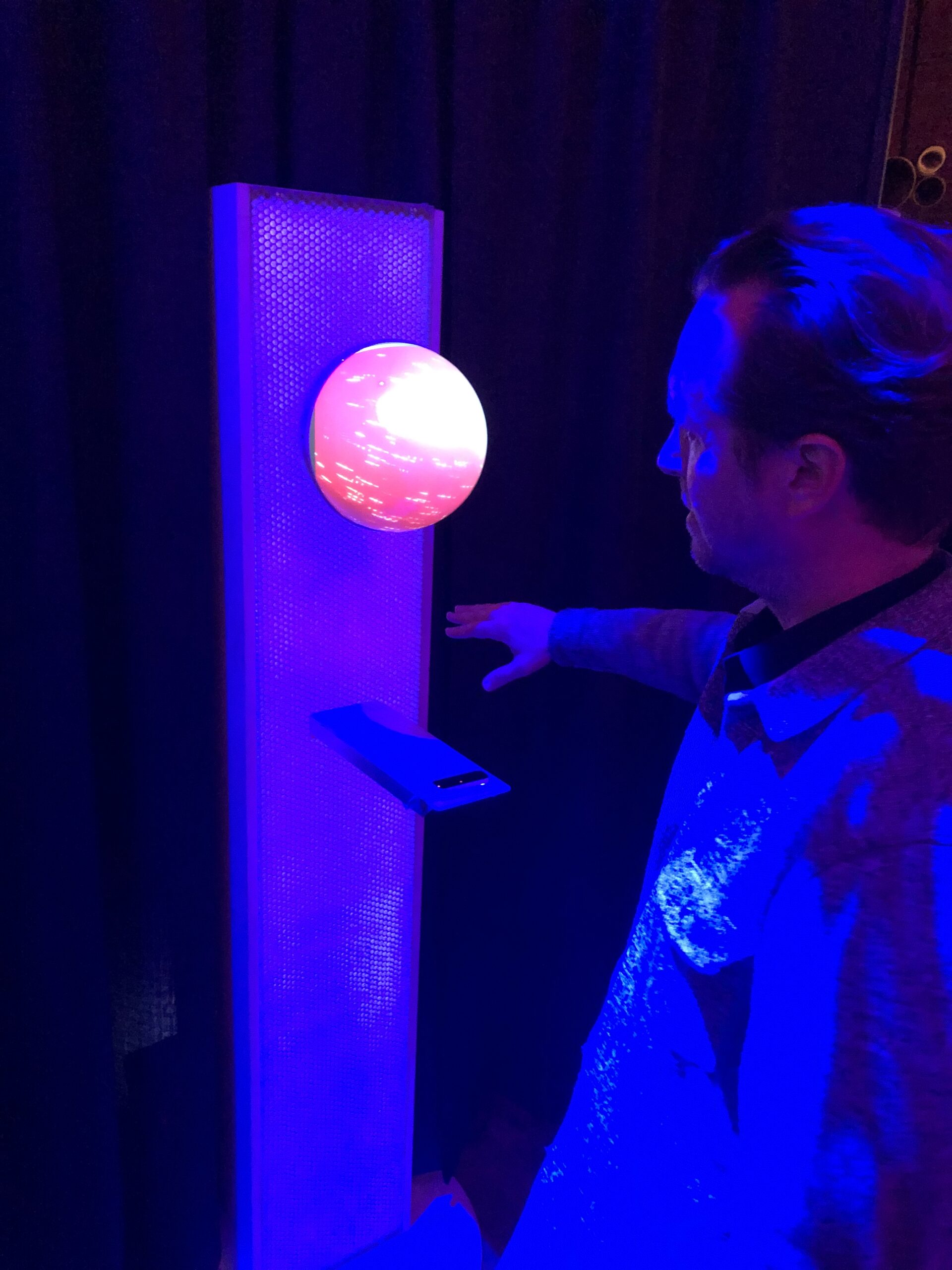 Close-up of The Orb spherical projector displaying particle visuals