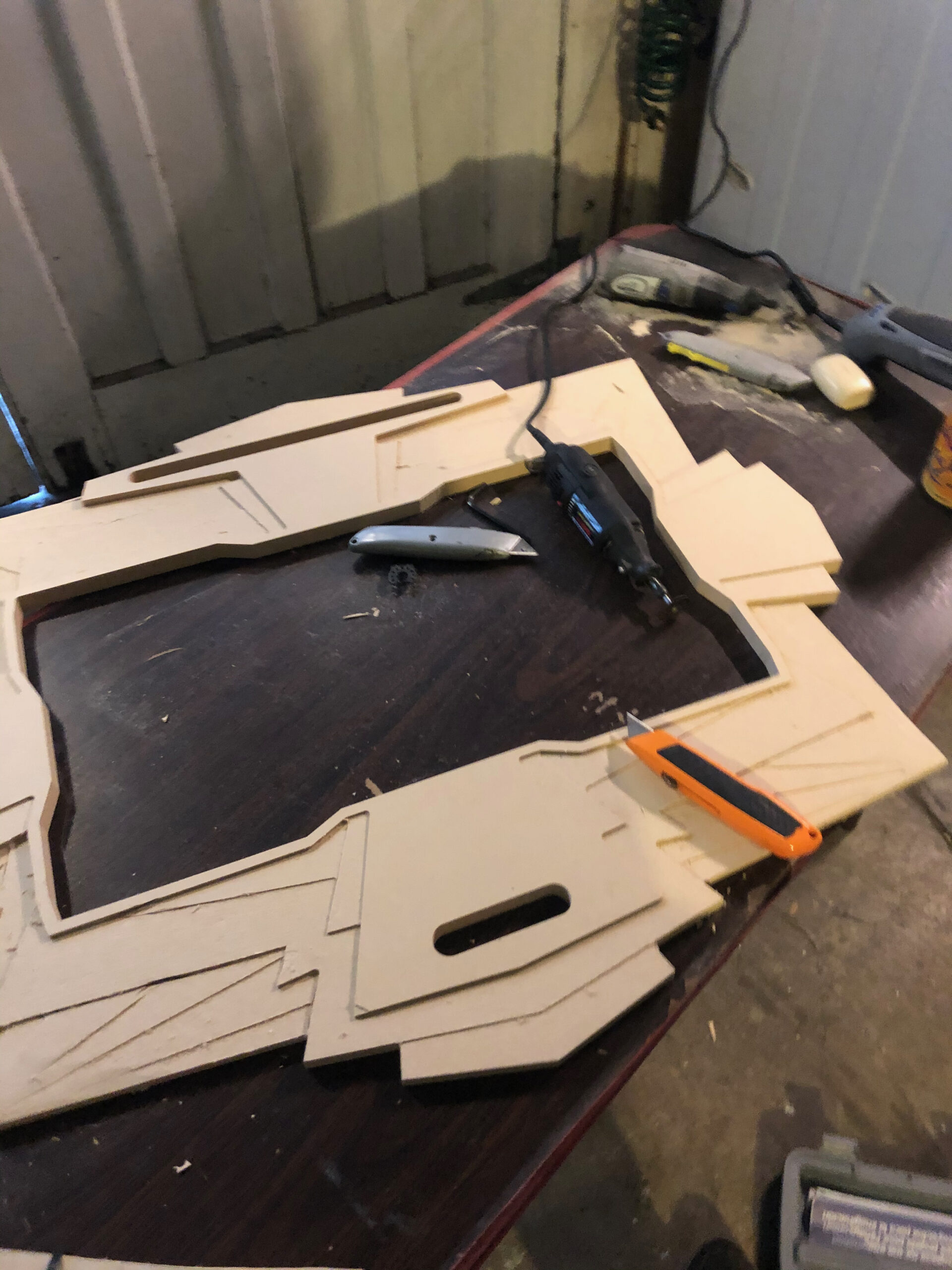 Cut MDF facade pieces laid out for assembly